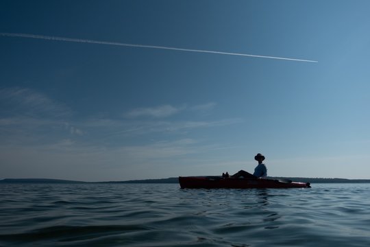 Silhouette Of A Person Kayaking On Lake Superior