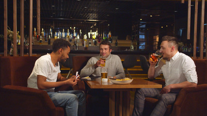 Friends sit at the bar, they put money in a bill one by one