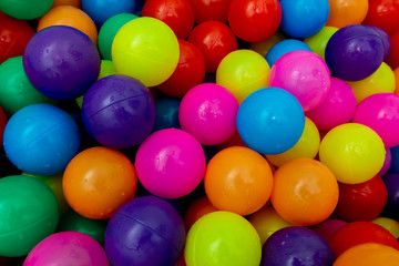 Fototapeta na wymiar Plastic multi-colored balls for a dry pool. A lot of bright colors. Kids toys. place for text.