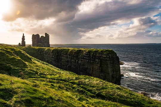 Coastal landscape of Northern Scotland with ruins of the Castle Sinclair Girnigoe, Near Wick at sunset.