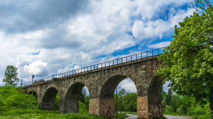 Fototapeta na wymiar The old Austrian operating railway viaduct in the resort village of Vorokhta. Ukraine. Carpathians