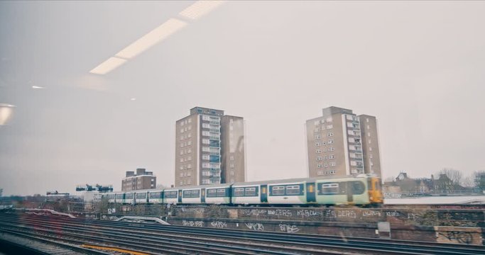 Commuter Train Passing Railway London City Skyline Flat Block Cloudy Transport