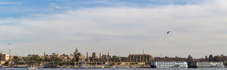 Luxor, Egypt, Karnak Temple, complex of Amun-Re. View of the ancient city of Thebes from the Nile. Panoramic city, view from the river.