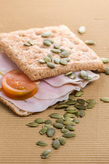 sandwich of ham and whole wheat bread with pipes