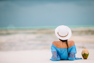 Fototapeta na wymiar Woman laying on the beach enjoying summer holidays looking at the sea