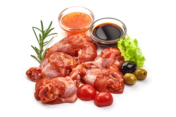 Raw chicken legs in a barbecue marinade, isolated on white background