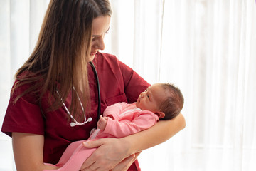 Pediatrician holding a beautiful newborn baby girl - 318694012