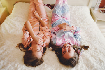 Cute girls at home. Ladies in a cute pajamas