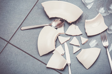 Broken Plate or broken water glass on the on the floor in the kitchen The concept of accidents in...