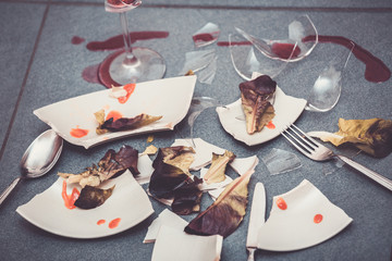 Broken Plate or broken water glass on the on the floor in the kitchen The concept of accidents in...