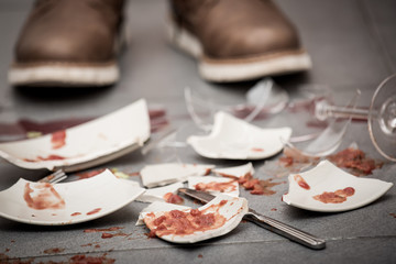 Broken Plate or broken water glass on the on the floor in the kitchen The concept of accidents in...