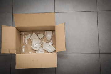 Broken plates or broken glass put in box in the kitchen. The concept of an accident in the kitchen...