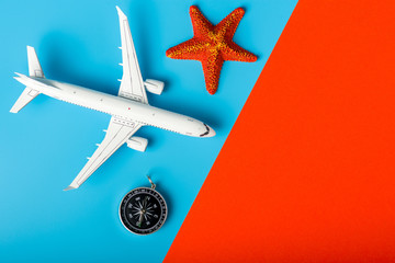 Airplane with starfish and compas - main travel or vacation souvenir. Fly travelling concept. Summer travel. Empty space for text © bychykhin