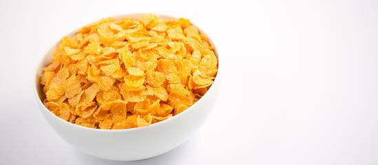 Natural corn flake breakfast cereal in cups and milk is a healthy breakfast that is good for your body every day on a white background.