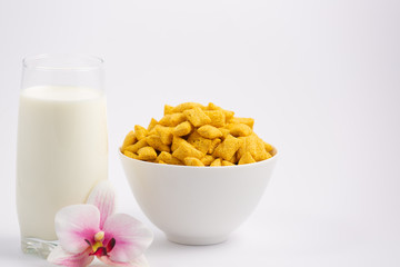 Breakfast cereal, cornflake, chocolate in cups and milk is a healthy breakfast that is healthy for the body every day on a white background.