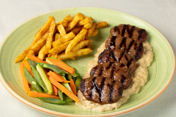 Grilled minced meat stakes served with french-fries and sauce