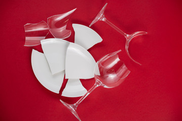 Broken Plate or broken water glass on the on the red background The concept of accidents in the...