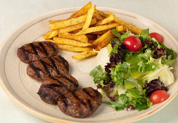 Grilled minced meat stakes served with french-fries and sauce