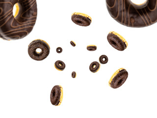 Falling chocolate donuts isolated on white background. Sweet sugar icing donuts.