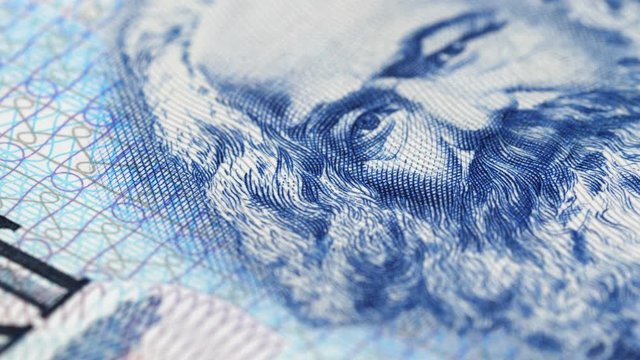 Karl Marx on East German banknote macro slow rotating. Philosopher, economist, sociologist, socialist. Founder of marxism and communism. Low angle. 4K, 422 10 bit