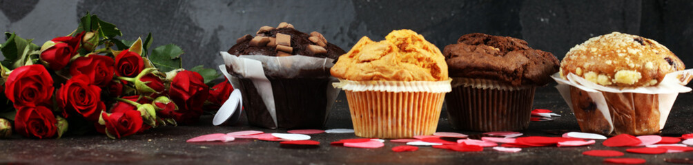 chocolate muffins, blueberry muffin and nut muffins on dark background for Valentine's day. tinting. selective focus