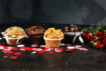 chocolate muffins, blueberry muffin and nut muffins on dark background for Valentine's day. tinting. selective focus