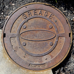 Rusty industrial metal grease cover.