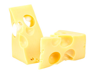 Standing and lying two triangular pieces of Maasdam cheese isolated on a white background