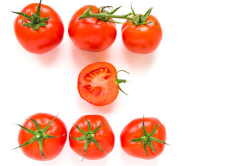 Group of delicious ripe red tomatoes lie in rows on white background. Top view. Healthy and organic food concept. 