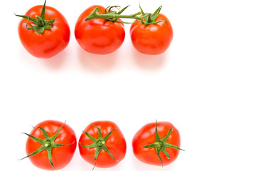 Group of delicious ripe red tomatoes lie in rows on white background. Top view. Healthy and organic food concept. 