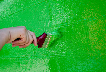 Paint the wall with a brush in green