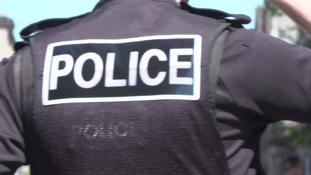 Police officer / Policeman in the UK. Wearing a Bullet Proof vest - Out on patrol