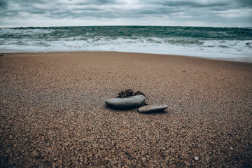 Fototapeta na wymiar stones and waves on the beach