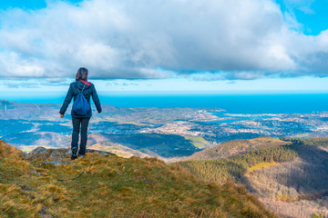 A young man watching Fuenterrabia from the mountain of Aiako Harria, Oiartzun. Basque Country