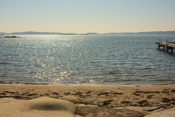 Sunny day at a sandy and empty beach.