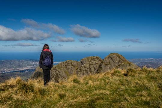 A young woman watching the views from Pe&ntilde;as de Aia, Guipuzkoa. Basque Country