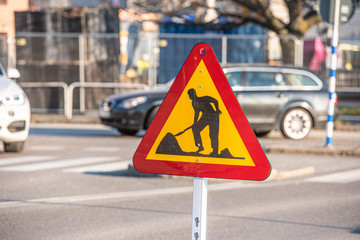 Sign showing roadworks at a crossing.