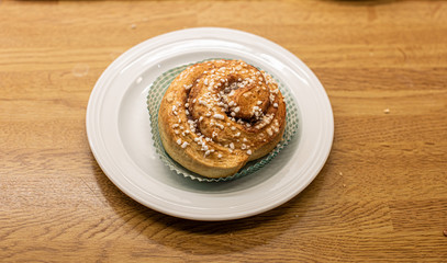 Tasty cinnamon bun on a plate.