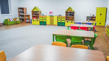 Chairs, table and toys. Interior of kindergarten.