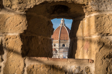 Detail of dome of Florence Duomo in a frame of old wall stones