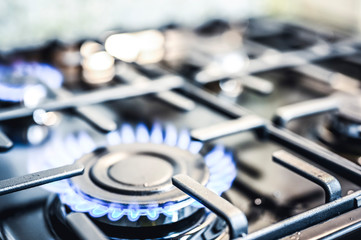 Kitchen stove cook. Kitchen gas cooker with burning blueflames fire propane gas.