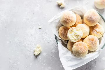 Sweet coconut cookies on a white plate, light grey concrete background. Coconut macaroon.