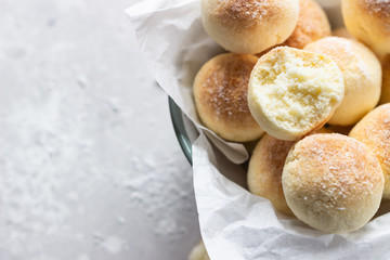 Sweet coconut cookies on a white plate, light grey concrete background. Coconut macaroon.
