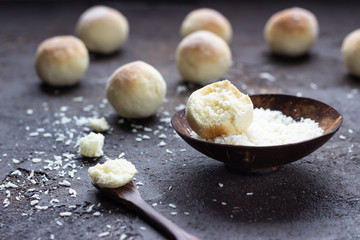 Cookies with coconut flakes, dark brown concrete background. Coconut macaroon.