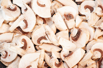 Porcini mushrooms lying sliced ​​in slices of a heating pan close-up.