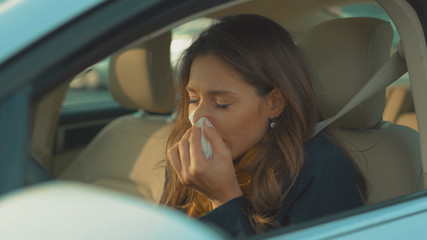 Face young woman sitting in car sneeze holds a handkerchief feeling sick vehicle influenza health illness flu medical sickness problem business infection headache slow motion