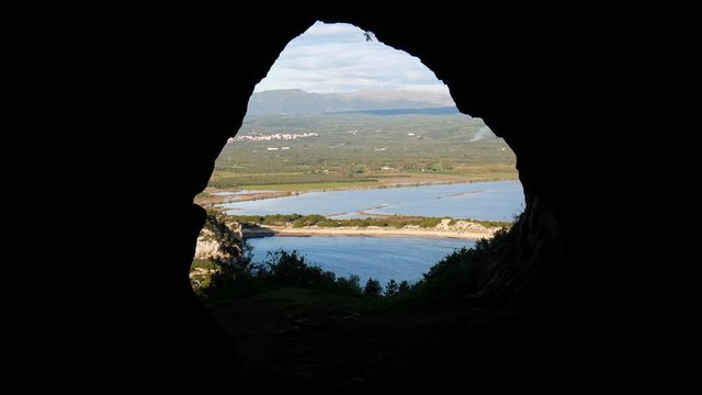 beautiful Voidokilia Beach and Gialova Lagoon on Mediterranean sea seen from the interior of Nestor's cave. Pylos-Nestor, Messenia, Peloponnese, Greece