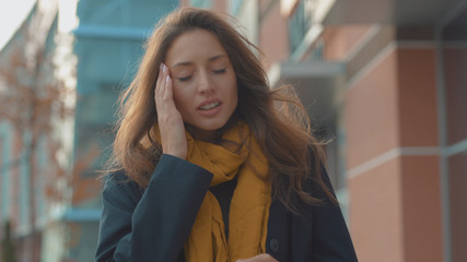Portrait young woman stand with headache look at camera sneezing feel sick at outdoor fever cold allergy city beautiful disease female nose lady runny tissue adult illness district slow motion