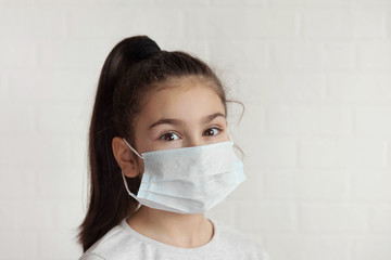 Child in a sterile medical mask. Sick little girl. Epidemic of flu. Virus, coronavirus.