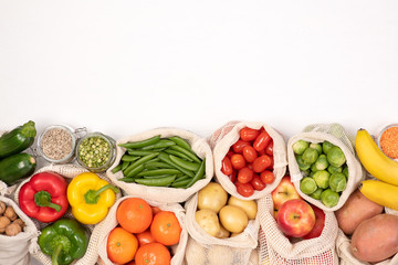 Zero waste concept. Fruits and vegetables in eco friendly reusable cotton bags. Top view with copy space